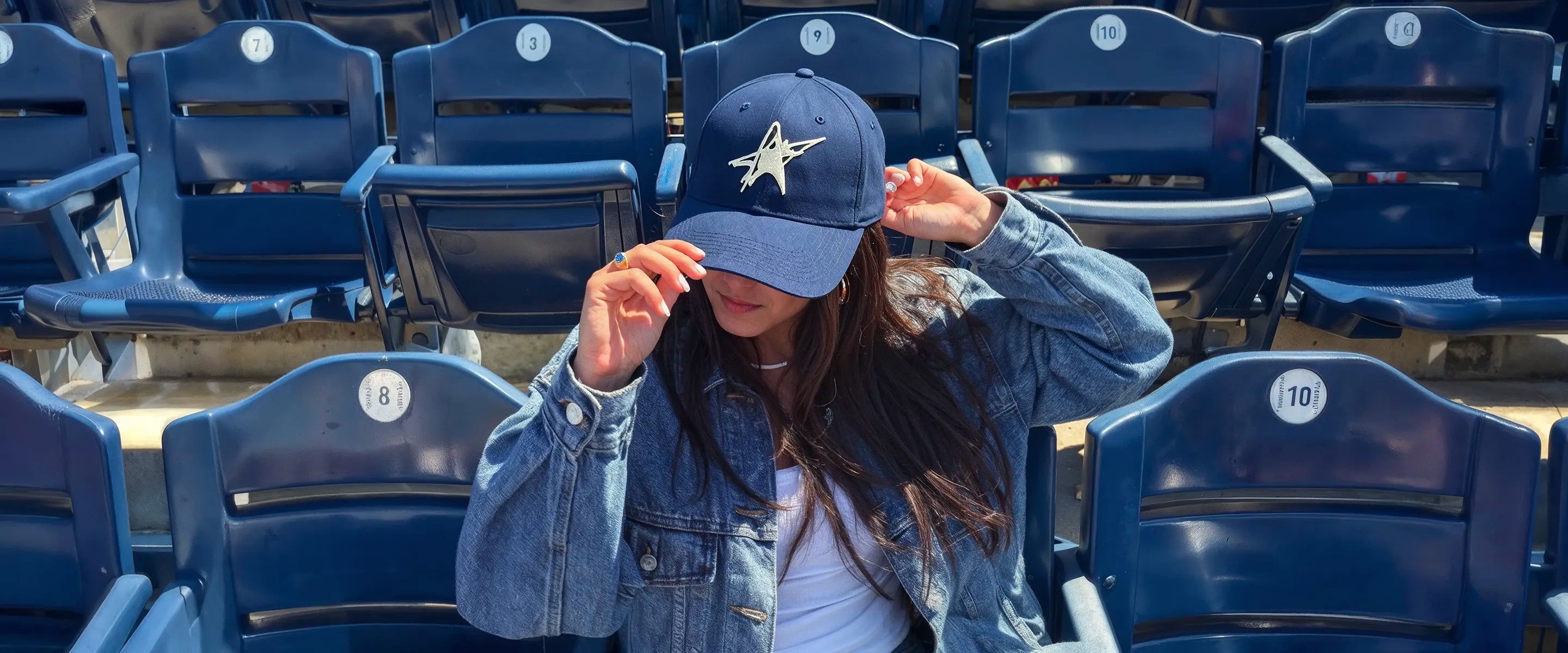 Lucidity Shine On Cap in navy with ivory embroidered star — worn in stadium seats — Read Between the Lines SS26